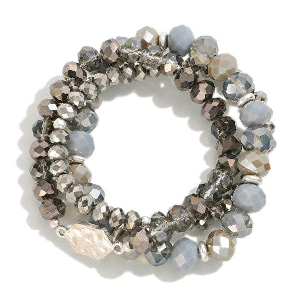 Set of Three Stretch Bracelets Featuring Faceted Beads and Hammered Metal Tone Charm Detail